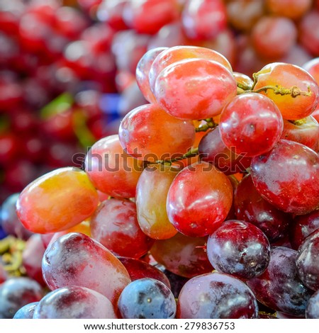 Group of fresh organically grown red grapes in the farmer market at Puyallup, Washington, USA. A close up full frame of grapes.