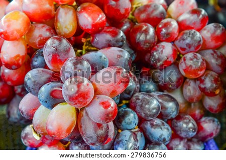 Group of fresh organically grown red grapes in the farmer market at Puyallup, Washington, USA. A close up full frame of grapes.