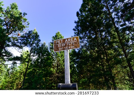 A sign for Pet area Ã¢Â?Â? keep pet on leash at the roadside rest area next to the highway I-90 of Washington State, US.