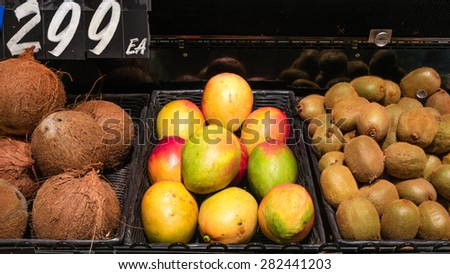 Group of coconut, mango and kiwi fruits in a supermarket at Colfax, Whitman County, Washington, USA. Close up and full frame view of fruits.