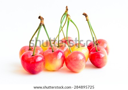 Group of Rainier  cherries on isolated white background. They are grown in Yakima Valley, a prime agricultural area of Washington State and the largest variety of crops in the Pacific Northwest, USA.