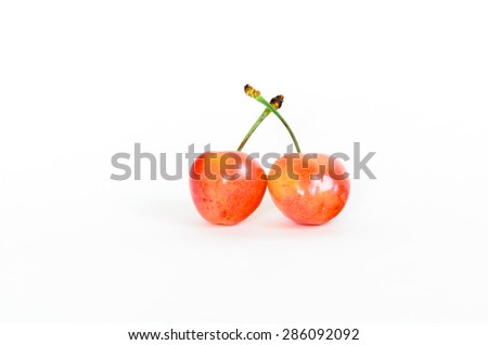 Two Rainier cherries on isolated white background. Rainiers are sweet cherries with a thin skin and thick creamy-yellow flesh. Panoramic style.