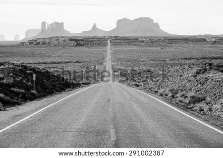 Desert highway leading into Monument Valley, Utah, USA. The view from  mile marker 13 on hwy 163.