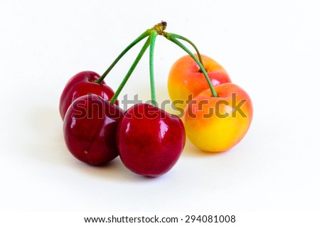 Fresh red and Rainier cherries isolated on white background. They are fresh picked in Yakima Valley, Washington State, USA. Cherries close-up. Healthy and colorful concept.