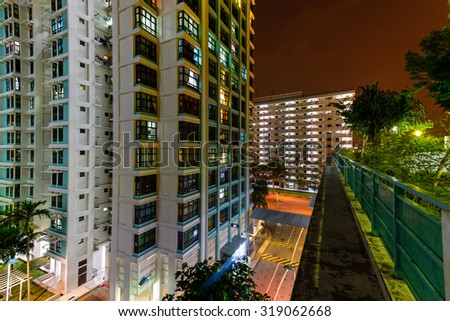 Aerial new estate with neighborhood faculties car park and green garden at the center at Eunos area of Singapore. Night view