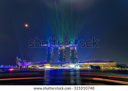 Full moon and lighting show over Singapore skylines. Mid-autumn is a big holiday in Asia with festival are held almost everywhere to celebrate with moon cake, lion dancing, lantern