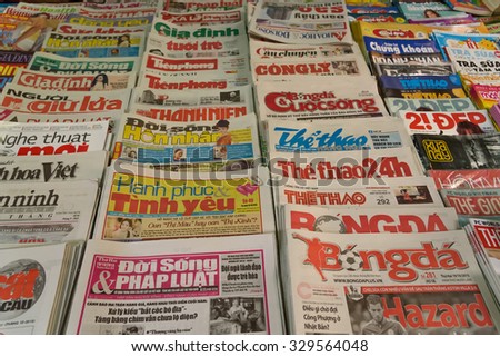 HANOI, VIETNAM - OCT 19, 2015: A newsstand with many daily newspapers on the sidewalk of a street in Hanoi capital. Vietnam has more than 600 state owned newspapers and media agencies