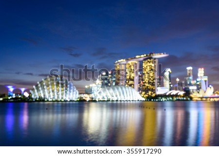 Blurred bokeh abstract motion of Singapore Skylines, Downtown and Financial District buildings reflection along the Singapore River at Blue Hour. Colorful bokeh lights  background of Modern City