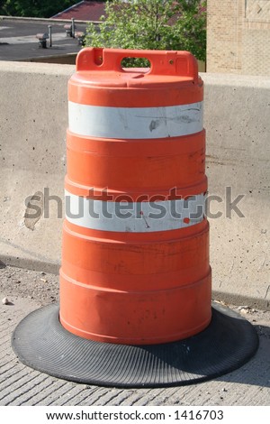 An orange construction barrel.