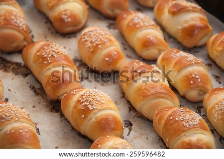 Mini croissants with cheese and sesame,just baked.Soft focus.