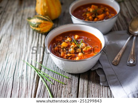 Vegetarian tasty spicy chili chick pea pumpkin wild rice soup pozole stew bowl on a wooden background