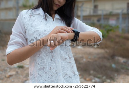 woman looking at her smart watch
