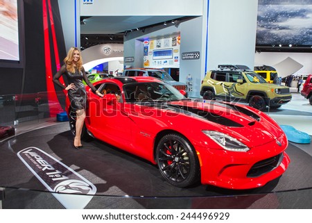 DETROIT - JANUARY 13: A show model poses with the Dodge Viper  January 13th, 2015 at the 2015 North American International Auto Show in Detroit, Michigan.