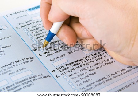 a person filling out a form with a pen