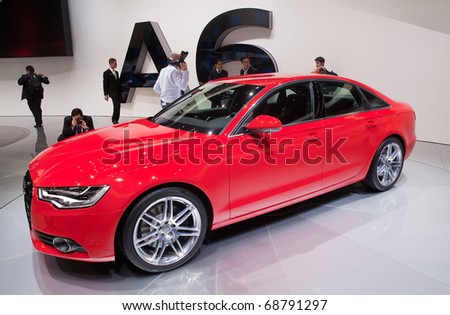 DETROIT - JANUARY 10: Reporters inspect the new 2011 Audi A6 at the 2011 North American International Auto Show Press Preview on January 10, 2011 in Detroit, Michigan.