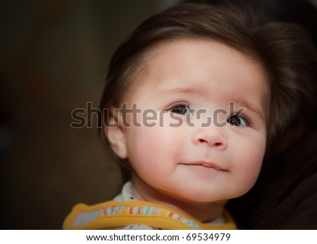 A baby with a hopeful face looking into the future
