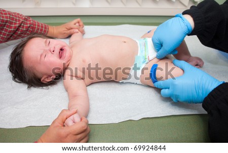 A baby crying after receiving a immunization shot