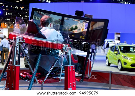 CHICAGO - FEB 8: A member of the media tests out Ford\'s virtual race track at the 2012 Chicago Auto Show Media Preview on February 8, 2012 in Chicago, Illinois.