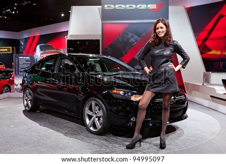 CHICAGO - FEB 8: A model poses with the all new 2013 Dodge Dart on display at the 2012 Chicago Auto Show Media Preview on February 8, 2012 in Chicago, Illinois.