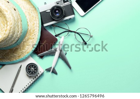 Travel accessories objects and gadgets top view flatlay on blue pastel