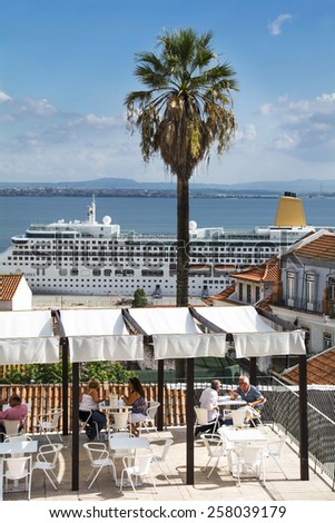 LISBON, PORTUGAL - SEPTEMBER 28:Tourists sit at a bar as a cruise ship departs on September 28, 2014 in Lisbon, Portugal.