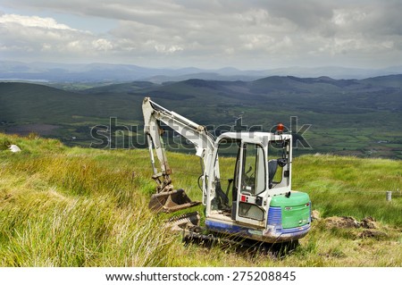 CORK,IRELAND - MARCH 30: Mini Digger in the Mountains West Cork on March 30, 2014 in Cork, Ireland.