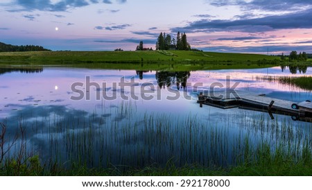 Calm river at midnight in eastern Finland by summer when it never gets darker.