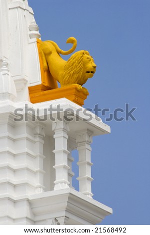Yellow lion sculpture,detail of Jain temple tower in Mombasa,Kenya