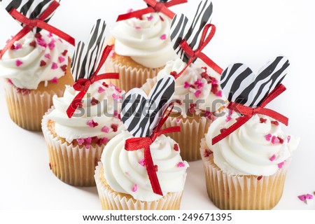 Closeup, delicious, sweet, icing mini cupcakes with valentine\'s decoration.