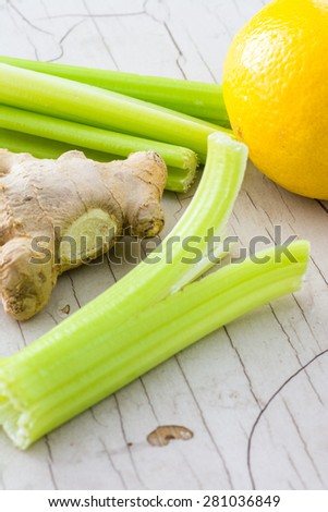 Closeup o ginger root and lemon and celery.