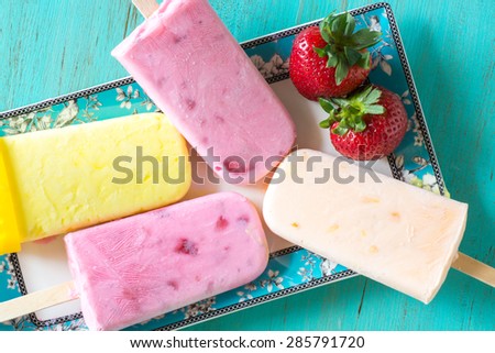Closeup of assorted breakfast - strawberry, orange, lemon ice pops.