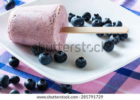 Closeup  of cold breakfast blueberry pops on a plate.