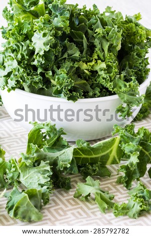 Closeup of bowl with fresh cut kale - ingredient for cold breakfast pops.
