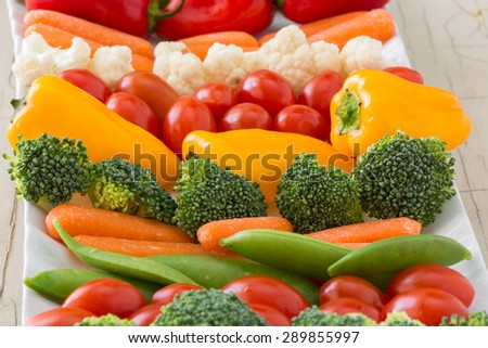 Closeup of vegetable tray with assorted cut vegetables and dip.