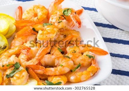 Close up of garlic butter roasted shrimps with vegetables.