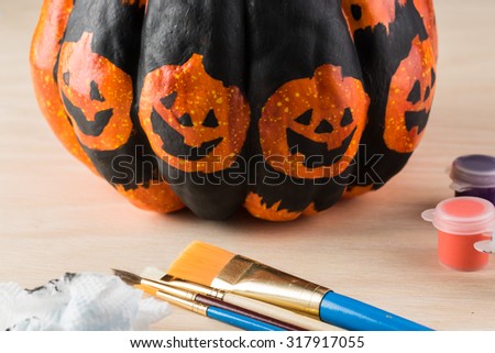 Close up of painting  a pumpkin for Halloween.