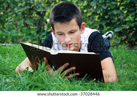 young boy in nature studying