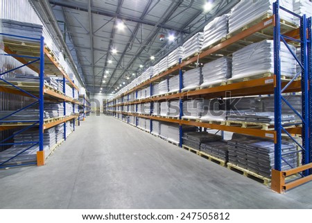 A large warehouse. Pallet metal racks with a heavy load.