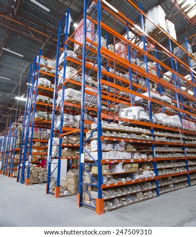 A large warehouse. Pallet metal racks with a heavy load.