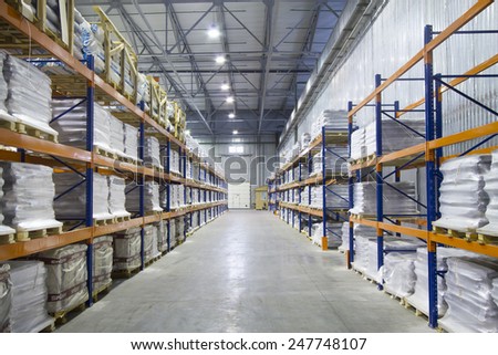 Large modern warehouse. Pallet metal racks with a heavy load.