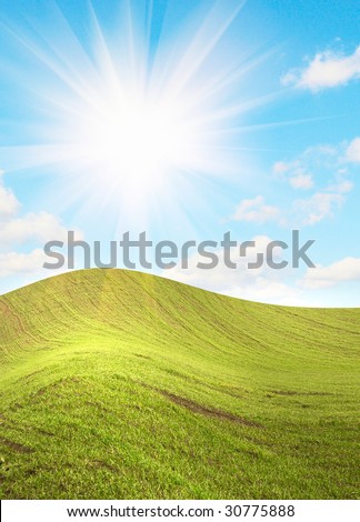 Summer landscape and beautiful sun beams over green field.