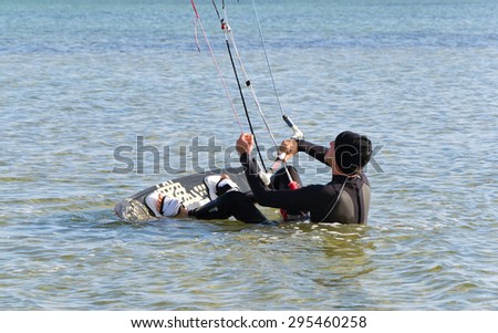 Kite Surfer gets up on the board on the Black Sea