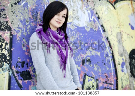 Teen girl near graffiti wall