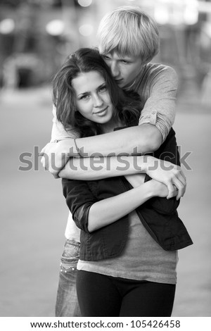 Young couple on the street of the city. Photo in black and white style.