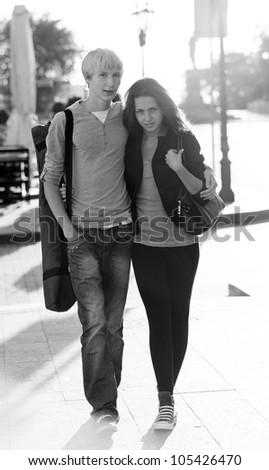 Young couple on the street of the city. Photo in black and white style.
