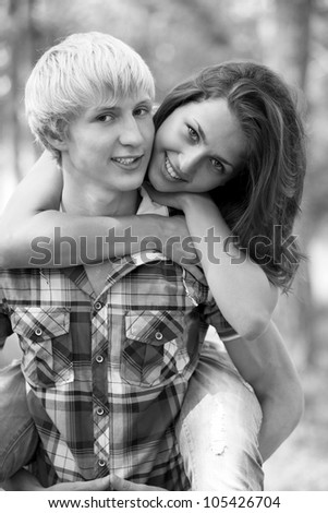 Young teenage couple in park. Photo in black and white style.