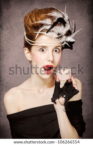 Redhead girl with Rococo hair style and cake in studio at vintage background. Photo in old style.