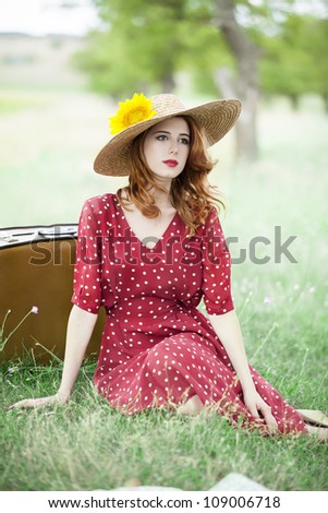 Redhead girl with sunflower at outdoor.