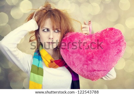 Sad girl with heart. St. Valentine Day. Photo with bokeh at background.