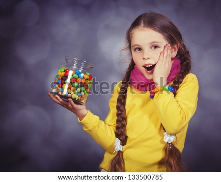 Little girl with jelly bean. Studio shot with a little noise
